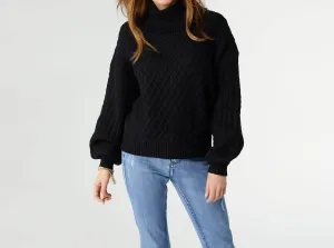Maren Cable Knit Turtleneck Sweater In Black